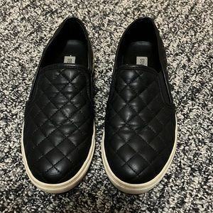 Black quilted pattern slip on sneakers